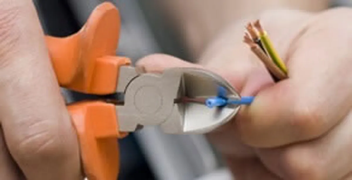 licensed electrician performing precise wire cutting and preparation during electrical service in Allentown, PA